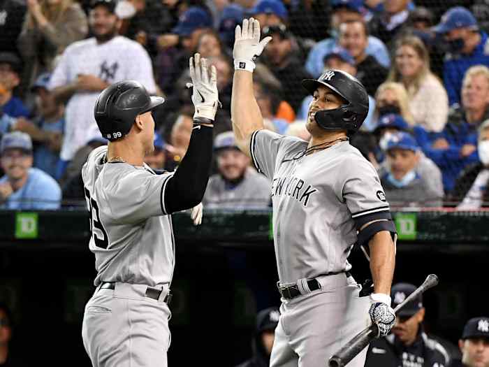 Sep 30, 2021; Toronto, Ontario, CAN; New York Yankees right fielder Aaron Judge (99) is greeted by left fielder Giancarlo Stanton (27) after hitting a solo home run against Toronto Blue Jays in the first inning at Rogers Centre.
